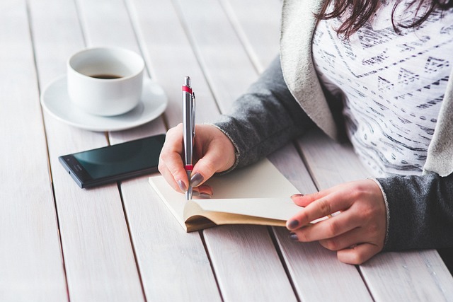 hand holding fountain pen writing calligraphy smooth strokes